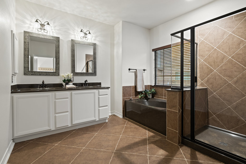 11217 Bastogne Loop Austin, TX 78739 - Photo 21 of 40 a bathroom with a granite countertop sink a mirror and shower
