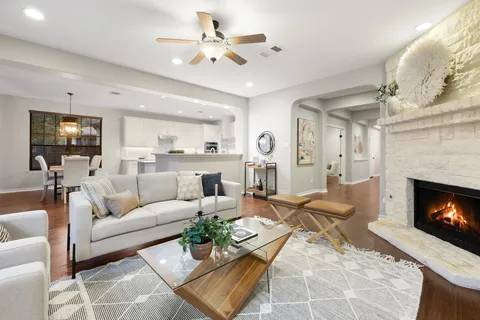 a living room with furniture kitchen view and a fireplace