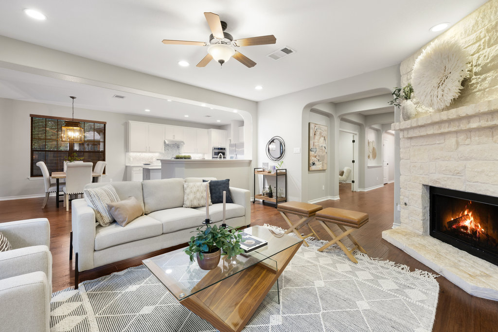 11217 Bastogne Loop Austin, TX 78739 - Photo 3 of 40 a living room with furniture kitchen view and a fireplace