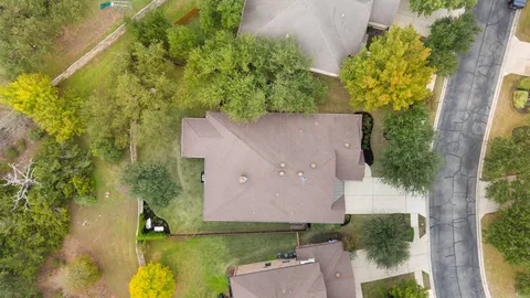 an aerial view of a house with a garden and yard