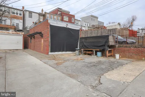 a bathroom with a granite countertop sink and a toilet