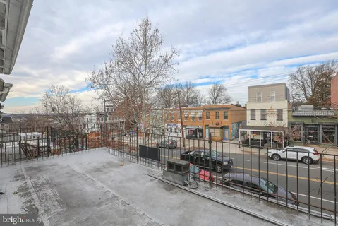 a living room with lots of furniture and a wooden floor