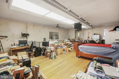 a room with furniture a window and stainless steel appliances