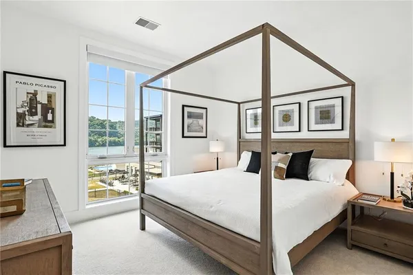 a bedroom with a large bed and a window