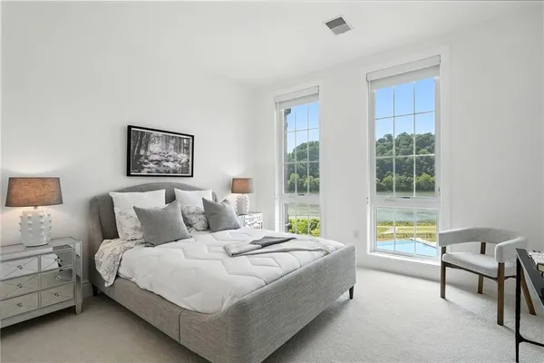 a bedroom with a bed and a window