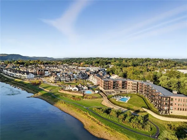 an aerial view of residential building and lake