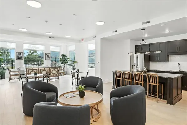 a living room with furniture kitchen and a large window