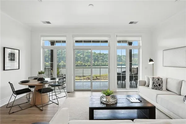 a living room with furniture and floor to ceiling windows
