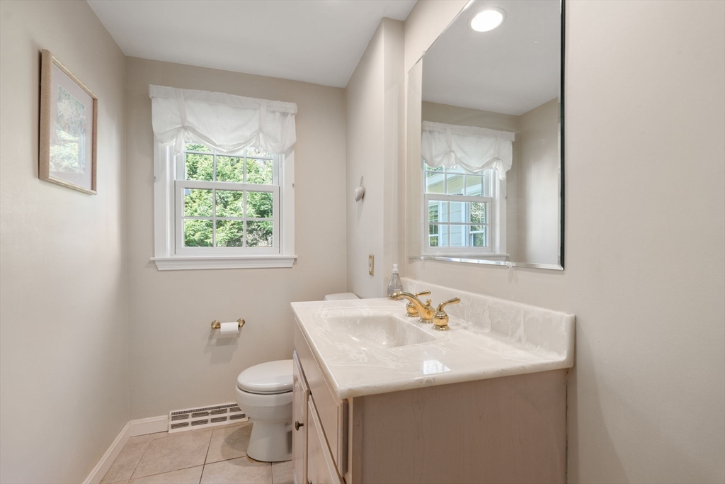 40 Amble Road Chelmsford, MA 01824 - Photo 14 of 26 a bathroom with a toilet sink and mirror