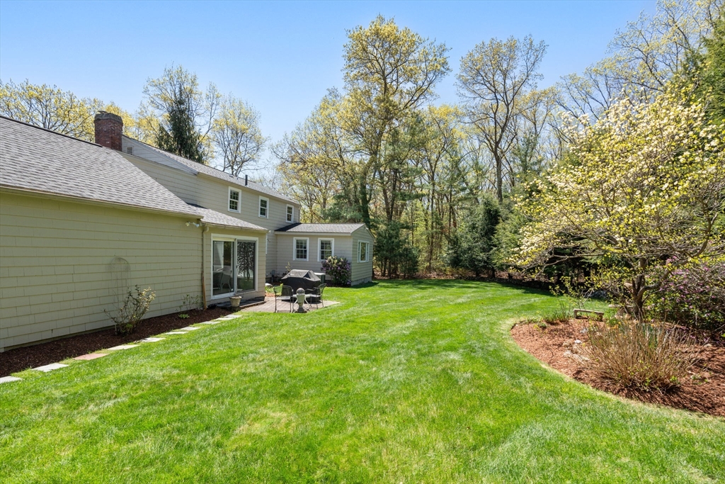 40 Amble Road Chelmsford, MA 01824 - Photo 23 of 26 a view of a backyard with table and chairs and potted plants and big trees