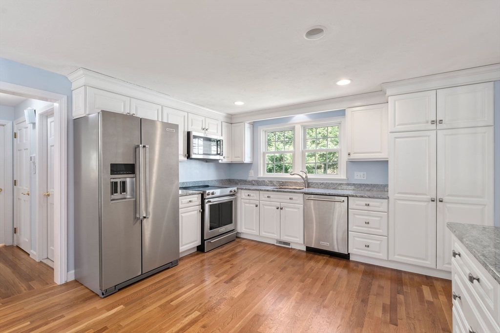 40 Amble Road Chelmsford, MA 01824 - Photo 7 of 26 a kitchen with granite countertop stainless steel appliances a refrigerator sink and cabinets