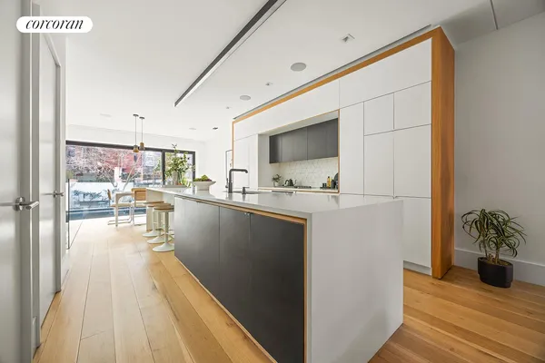 a kitchen with sink a stove and cabinets