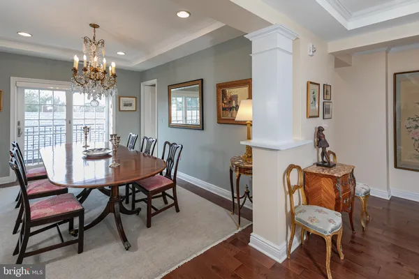 a view of a dining room with furniture and chandelier