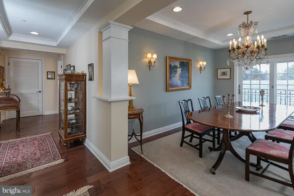 a view of a dining room with furniture and chandelier