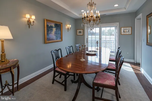 a view of a dining room with furniture and chandelier