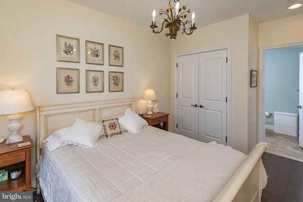 a bedroom with a bed and a chandelier
