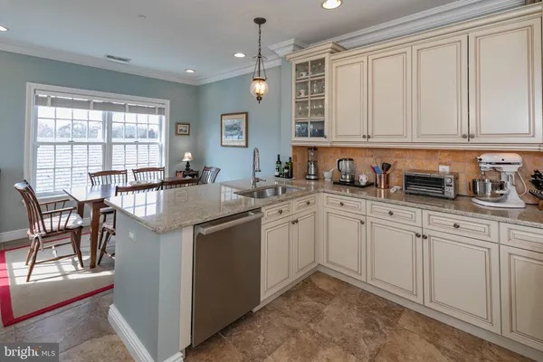 a kitchen with stainless steel appliances granite countertop a sink stove and cabinets