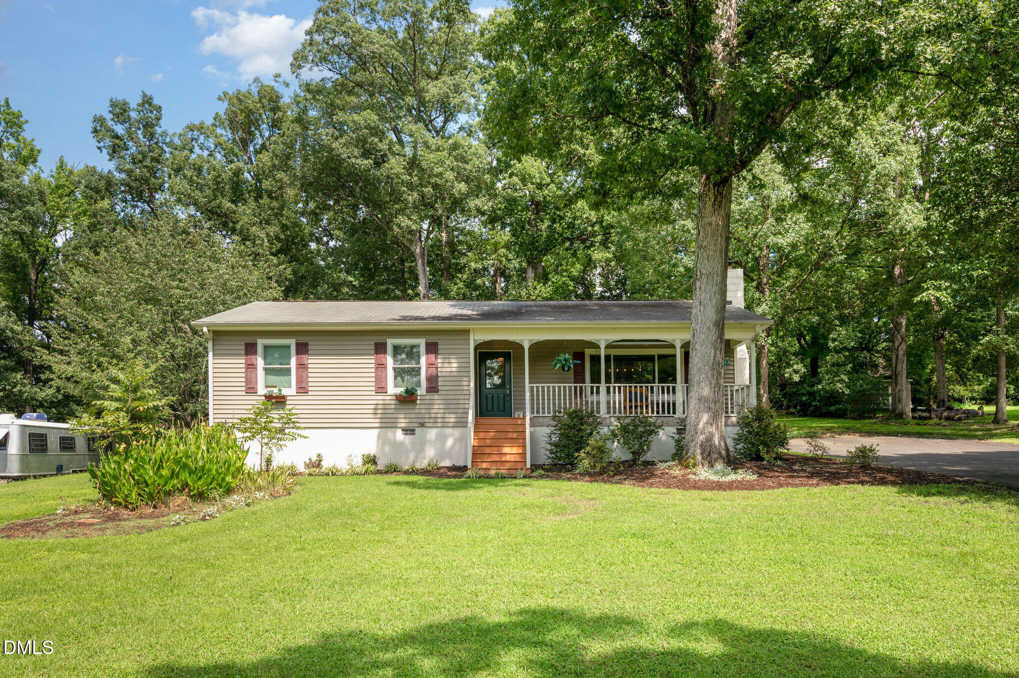a front view of house with yard and green space