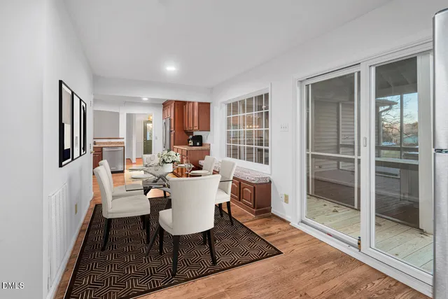 a view of a dining room with furniture window and wooden floor