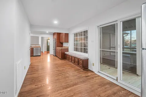a view of a living room with furniture and wooden floor
