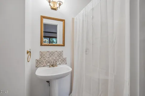 a bathroom with a sink a mirror and a toilet
