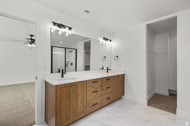 1661 West Ross Road Syracuse, UT 84075 - Photo 17 of 28 Full bath featuring double vanity, a shower stall, light carpet, a ceiling fan, and a walk in closet