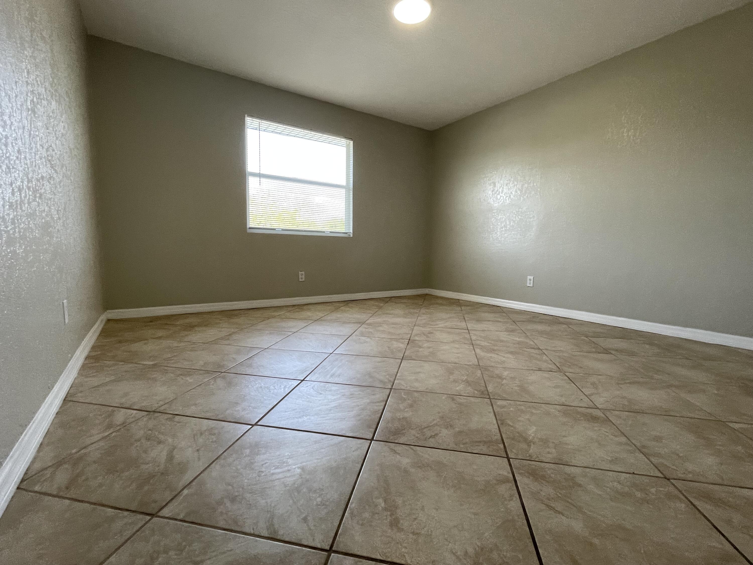 2880 Harson Way Fort Pierce, FL 34946 - Photo 17 of 40 a view of an empty room with a window