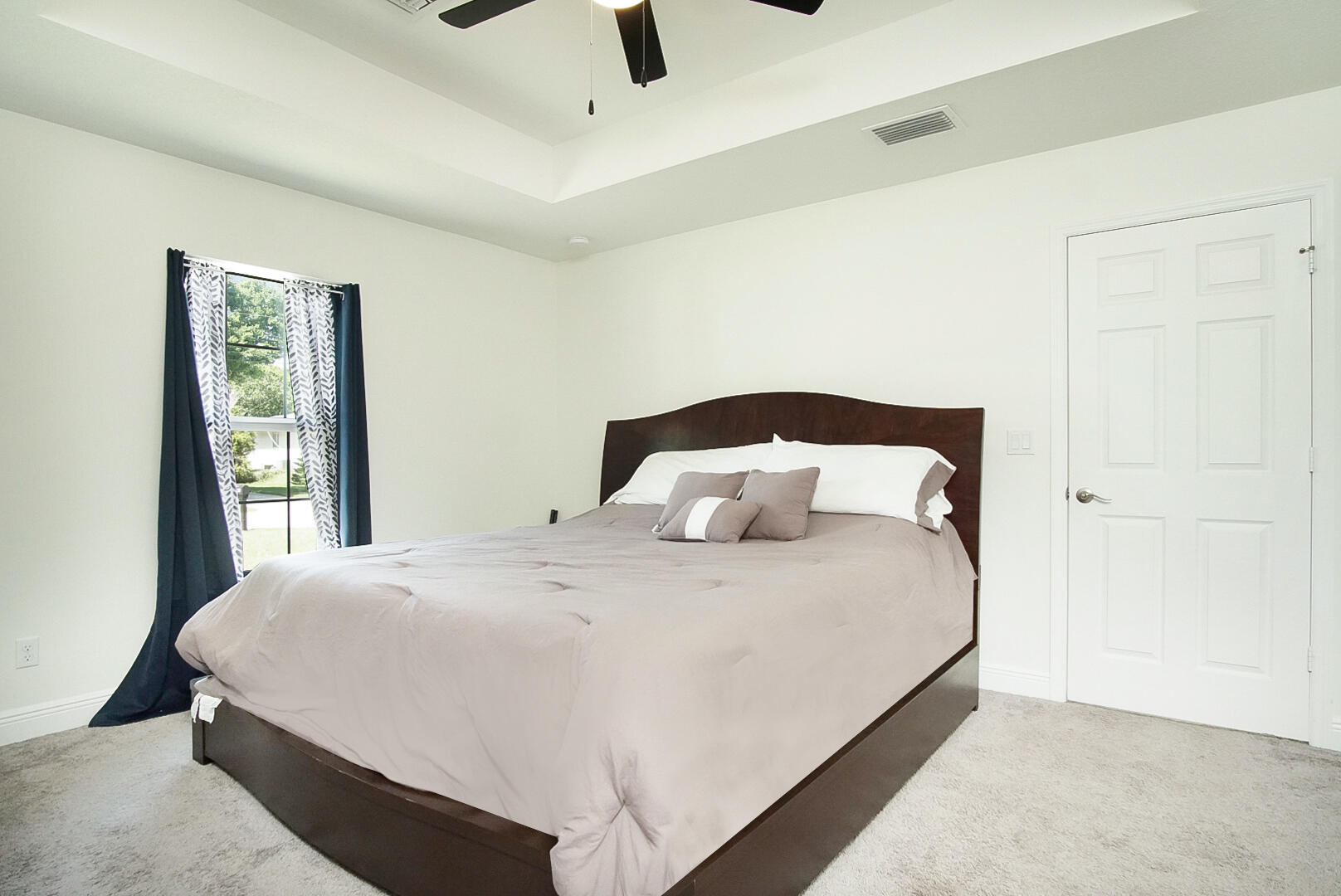 5302 Seagrape Drive Fort Pierce, FL 34982 - Photo 13 of 35 a bedroom with a bed and large windows