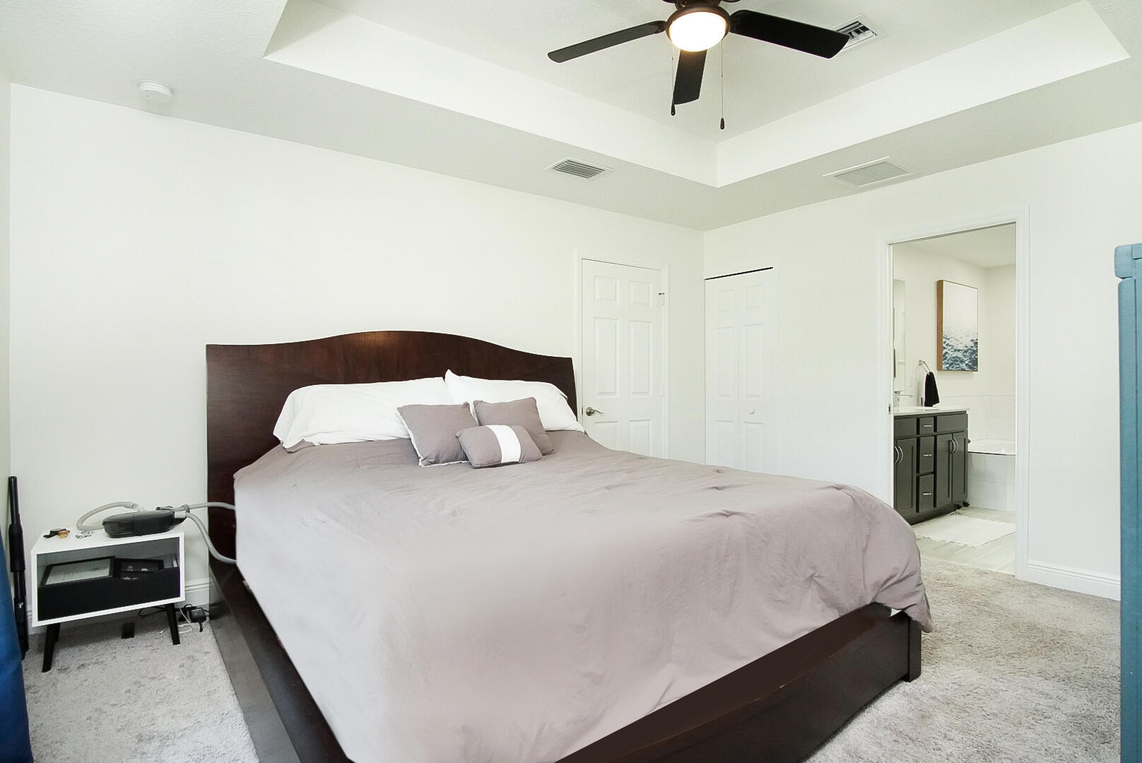 5302 Seagrape Drive Fort Pierce, FL 34982 - Photo 14 of 35 a bedroom with bed and a chandelier