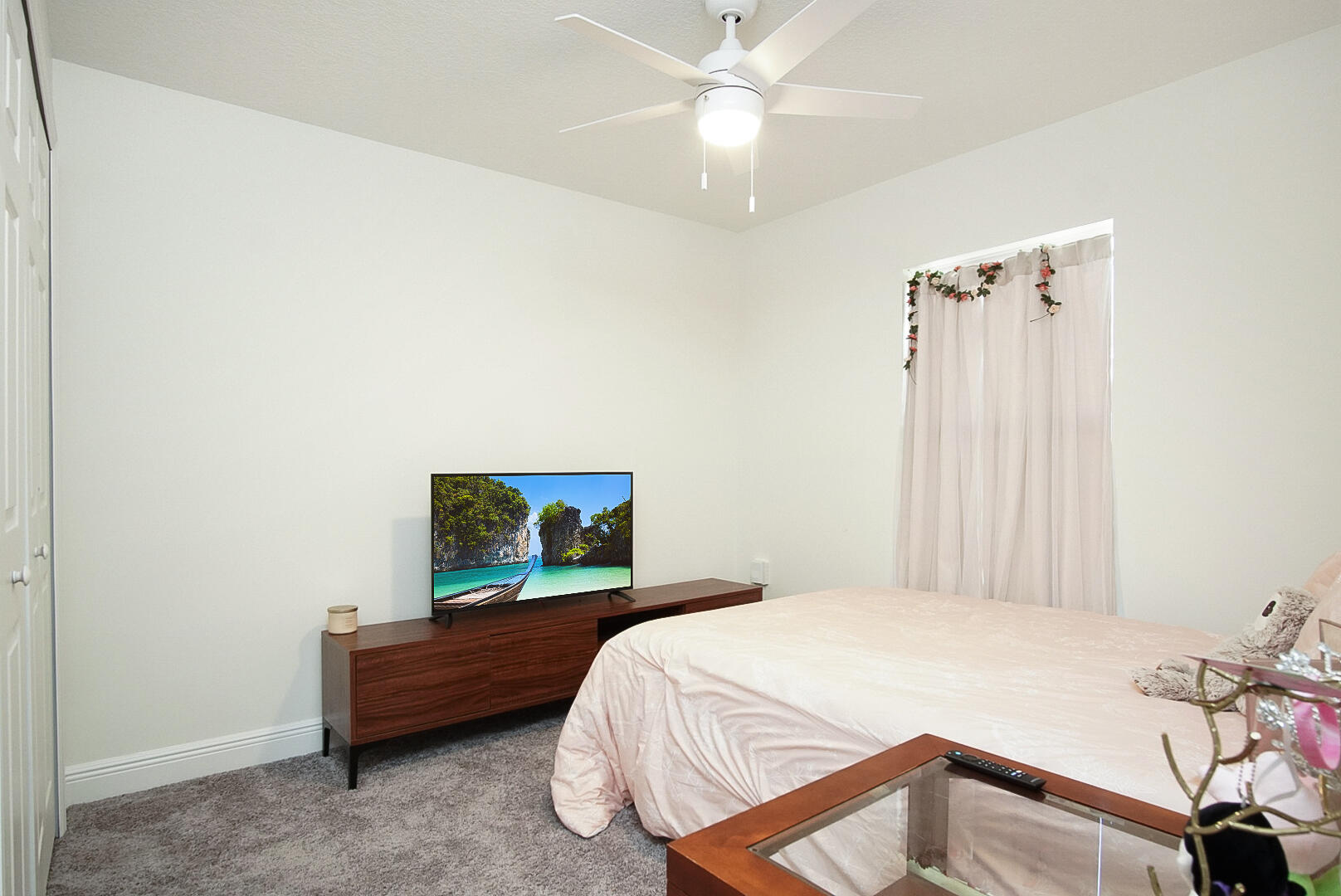 5302 Seagrape Drive Fort Pierce, FL 34982 - Photo 20 of 35 a bedroom with a bed and a chandelier