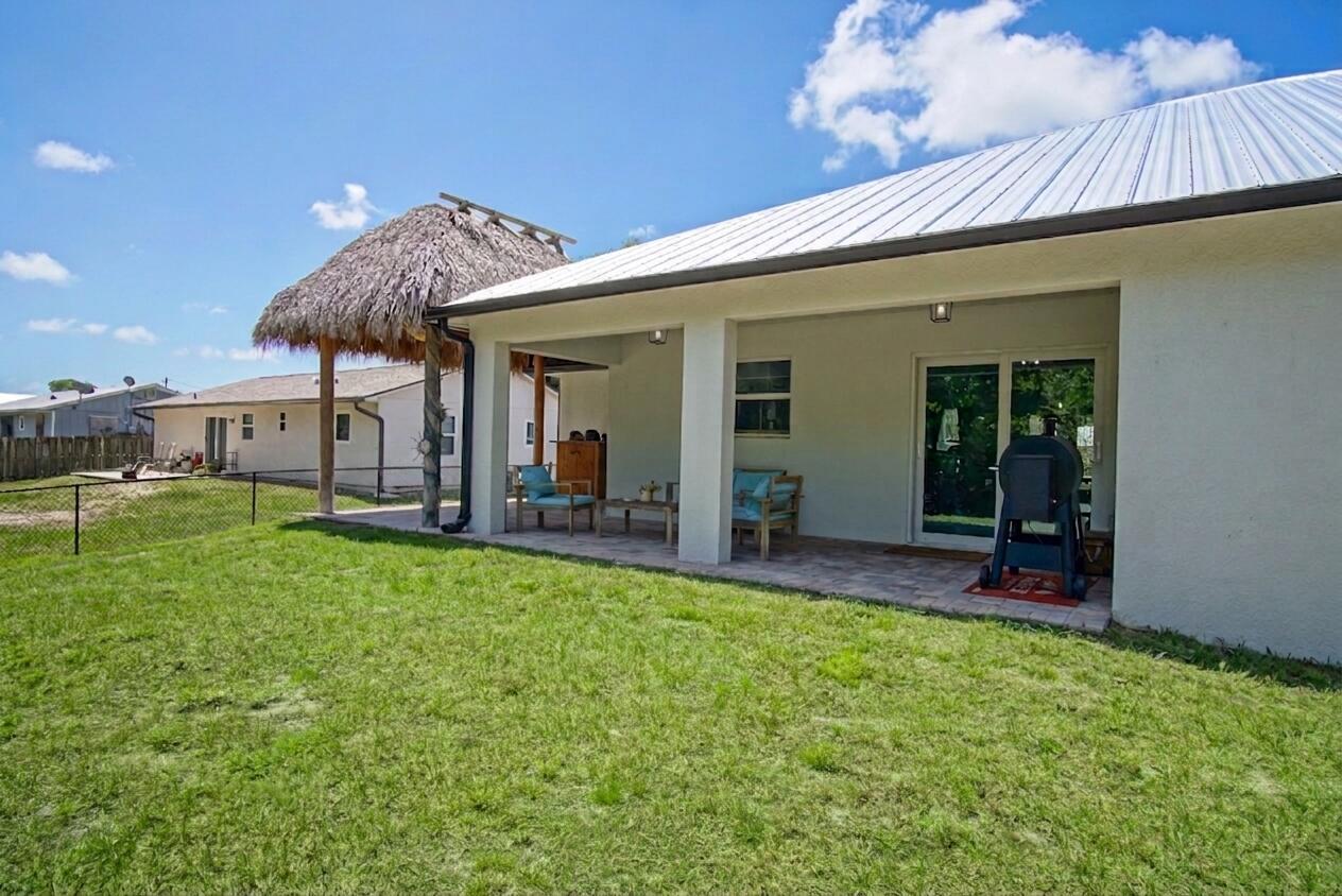 5302 Seagrape Drive Fort Pierce, FL 34982 - Photo 29 of 35 a view of a house with backyard porch and furniture