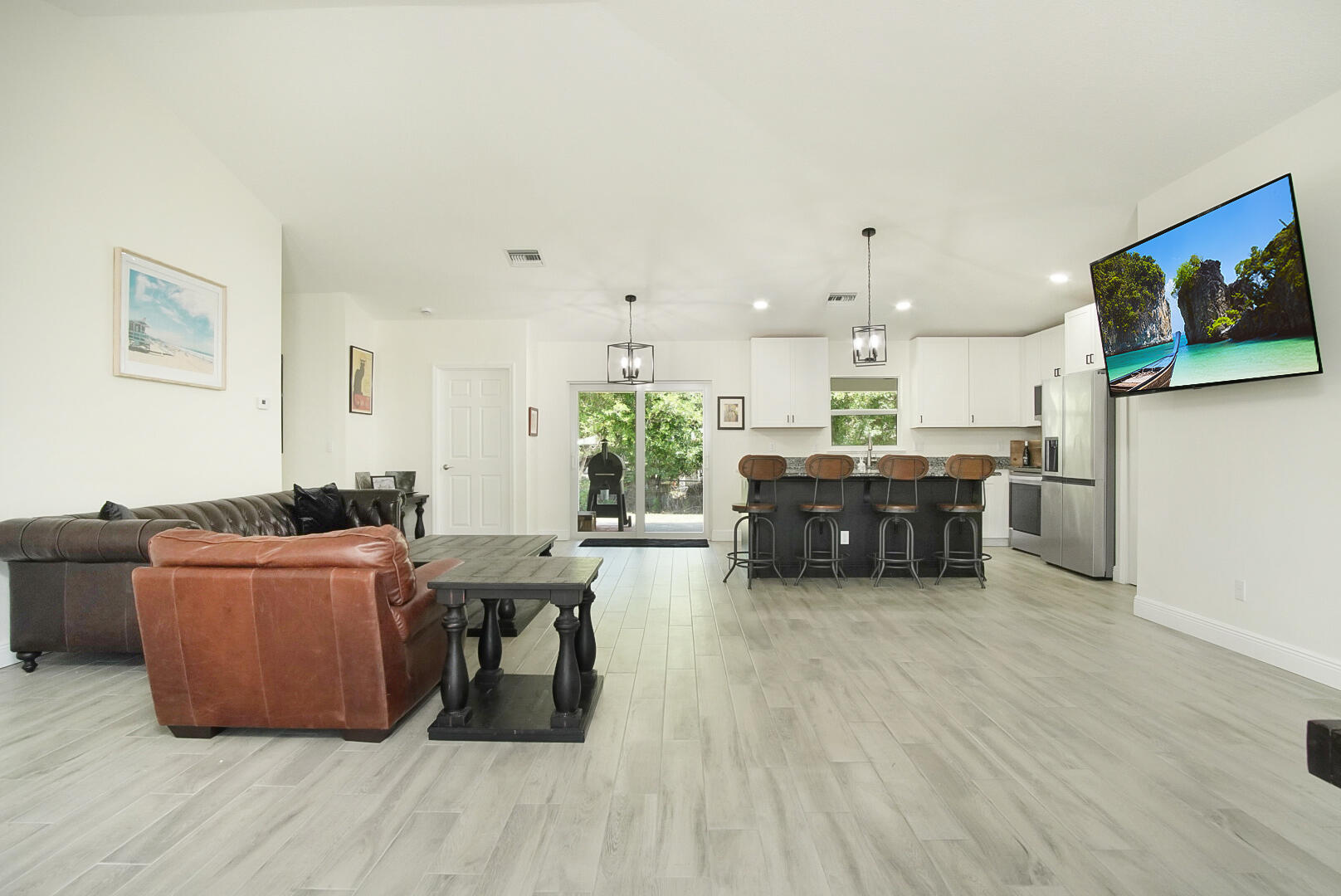 5302 Seagrape Drive Fort Pierce, FL 34982 - Photo 32 of 35 a living room with couches and kitchen view with wooden floor