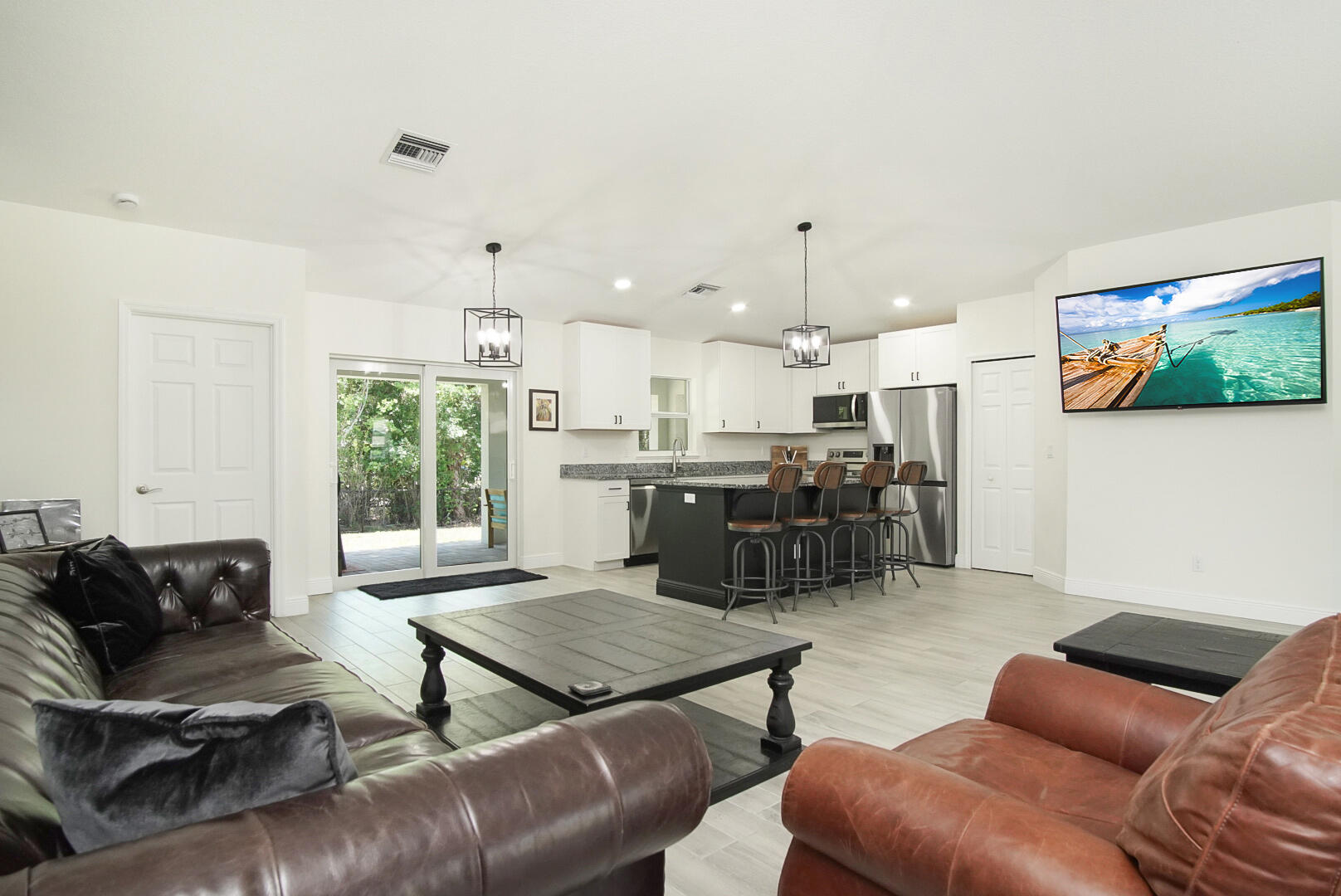 5302 Seagrape Drive Fort Pierce, FL 34982 - Photo 33 of 35 a living room with furniture and kitchen view