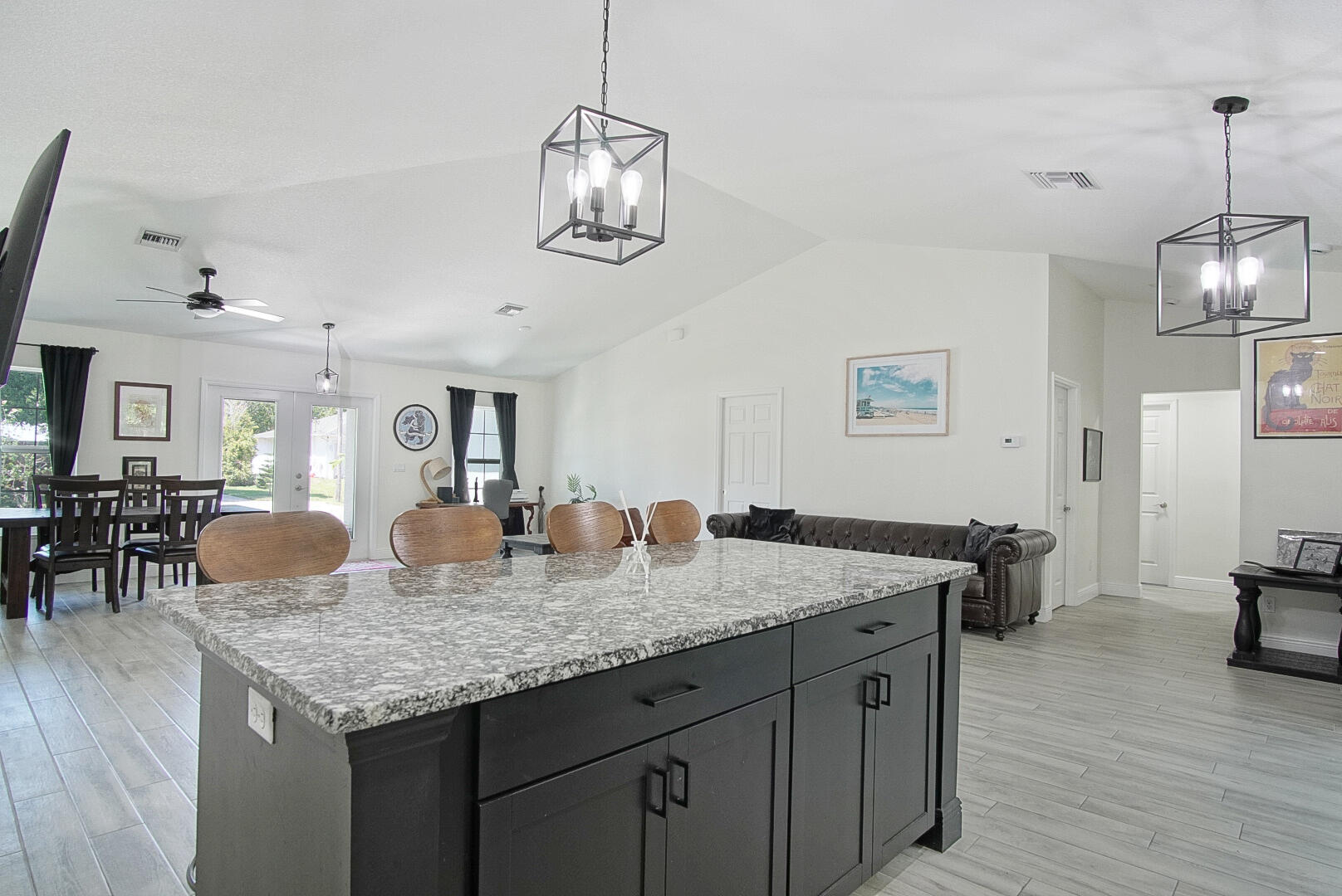 5302 Seagrape Drive Fort Pierce, FL 34982 - Photo 10 of 35 a kitchen with granite countertop kitchen island stainless steel appliances a dining table and chairs