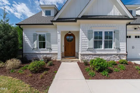 a living room with furniture large window and flat screen tv