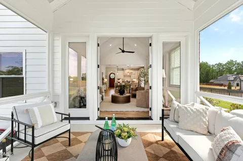a view of a house with pool and chairs