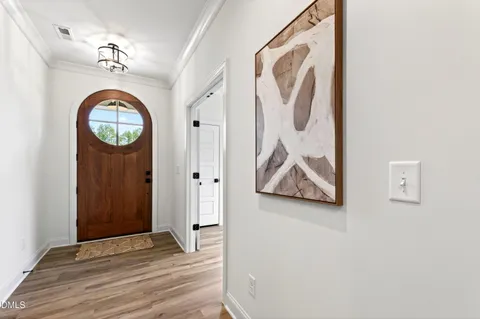 a dining room with furniture and wooden floor