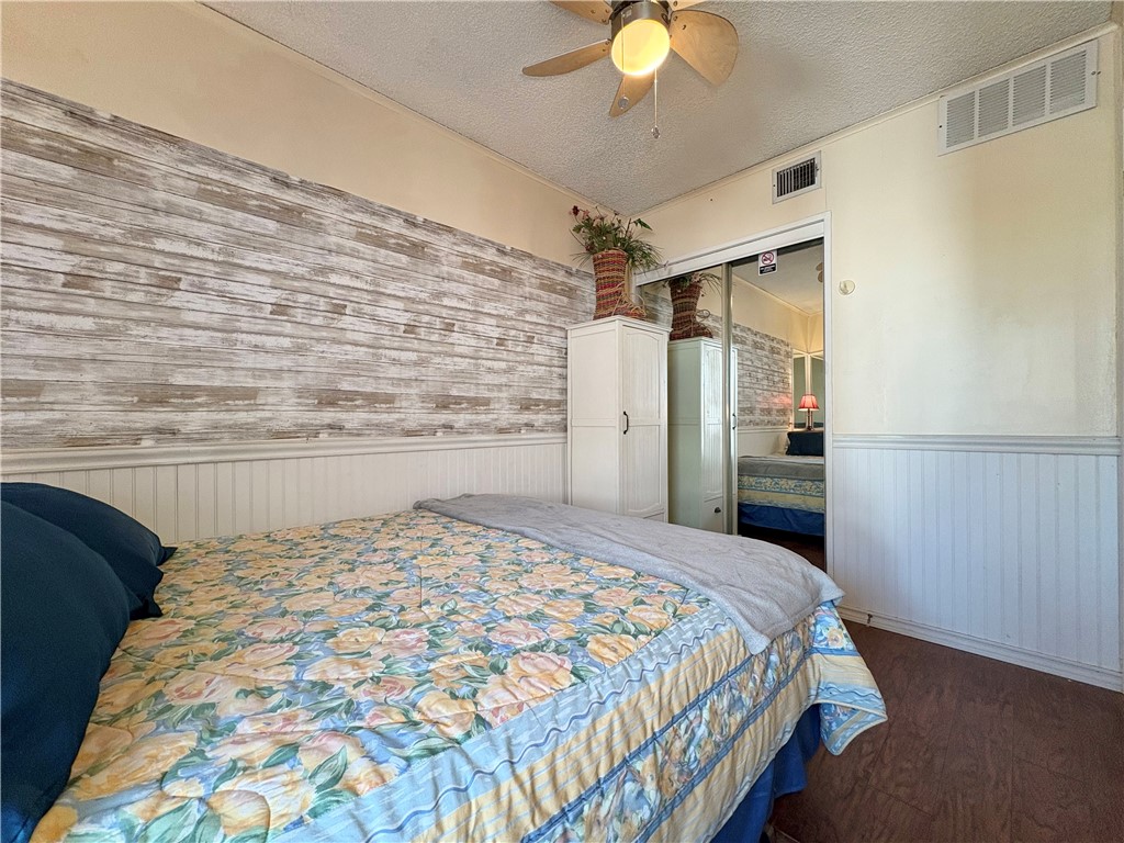 3938 Surfside, Unit 3233 Corpus Christi, TX 78402 - Photo 11 of 23 a bedroom with a bed and a chandelier