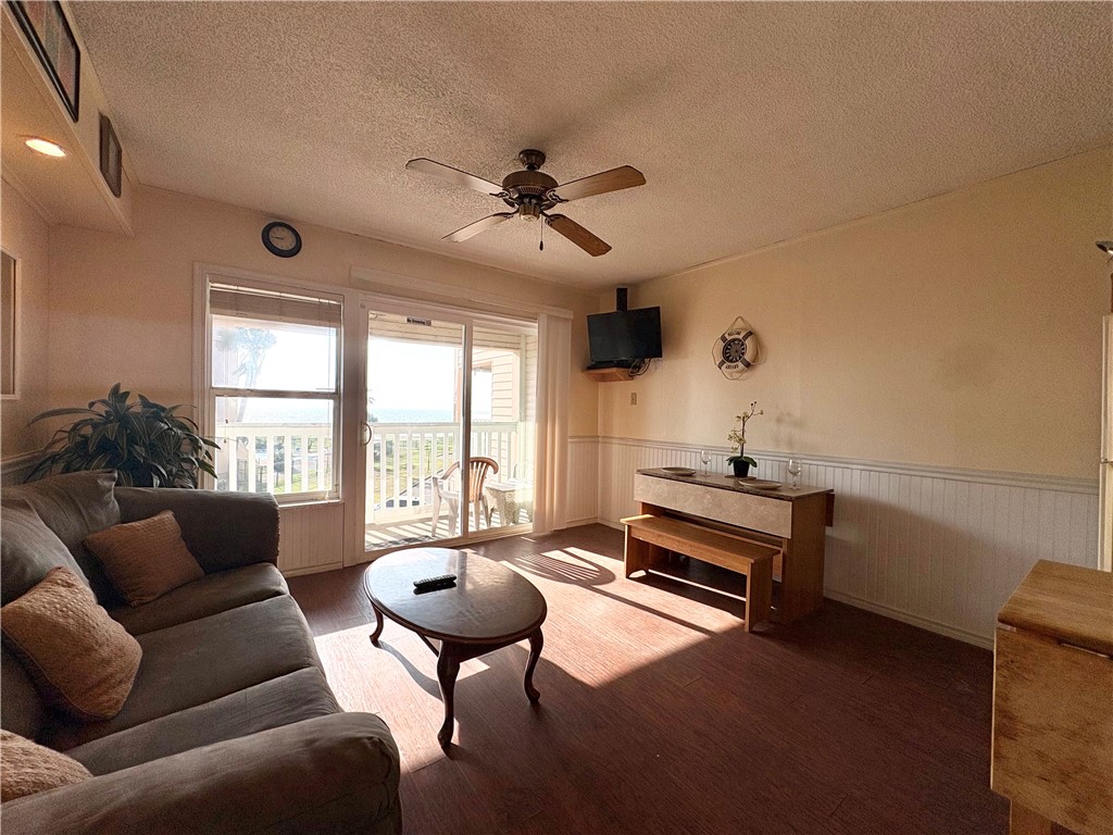 3938 Surfside, Unit 3233 Corpus Christi, TX 78402 - Photo 5 of 23 a living room with furniture a ceiling fan and a window