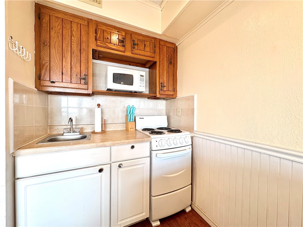 3938 Surfside, Unit 3233 Corpus Christi, TX 78402 - Photo 9 of 23 a kitchen with cabinets appliances and a sink
