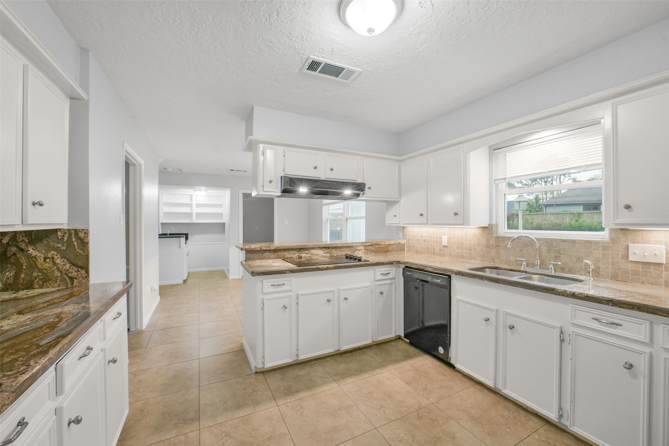7611 Theisswood Road Spring, TX 77379 - Photo 15 of 41 a large kitchen with a sink and cabinets