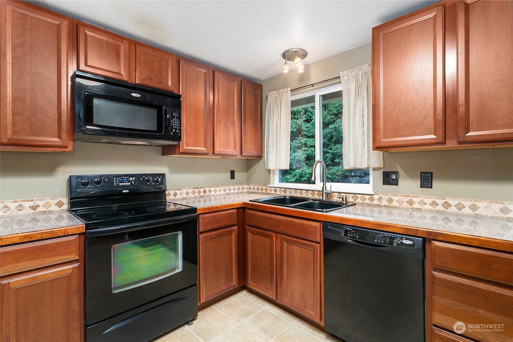 26007 36th Place South Kent, WA 98032 - Photo 11 of 37 a kitchen with a sink stove and microwave