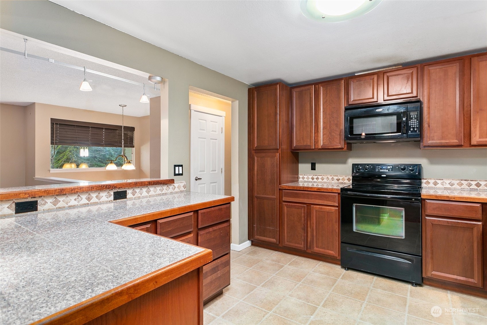 26007 36th Place South Kent, WA 98032 - Photo 13 of 37 a kitchen with stainless steel appliances granite countertop a stove microwave and sink
