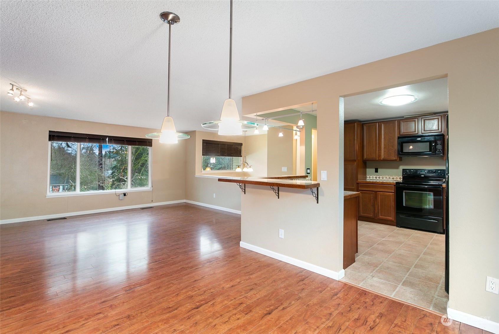 26007 36th Place South Kent, WA 98032 - Photo 15 of 37 a view of kitchen with kitchen island wooden floor center island and stainless steel appliances