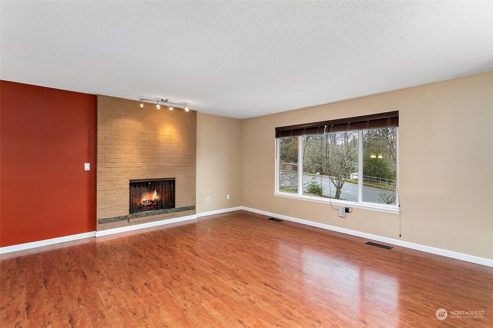 26007 36th Place South Kent, WA 98032 - Photo 2 of 37 a view of an empty room with a fireplace and a window