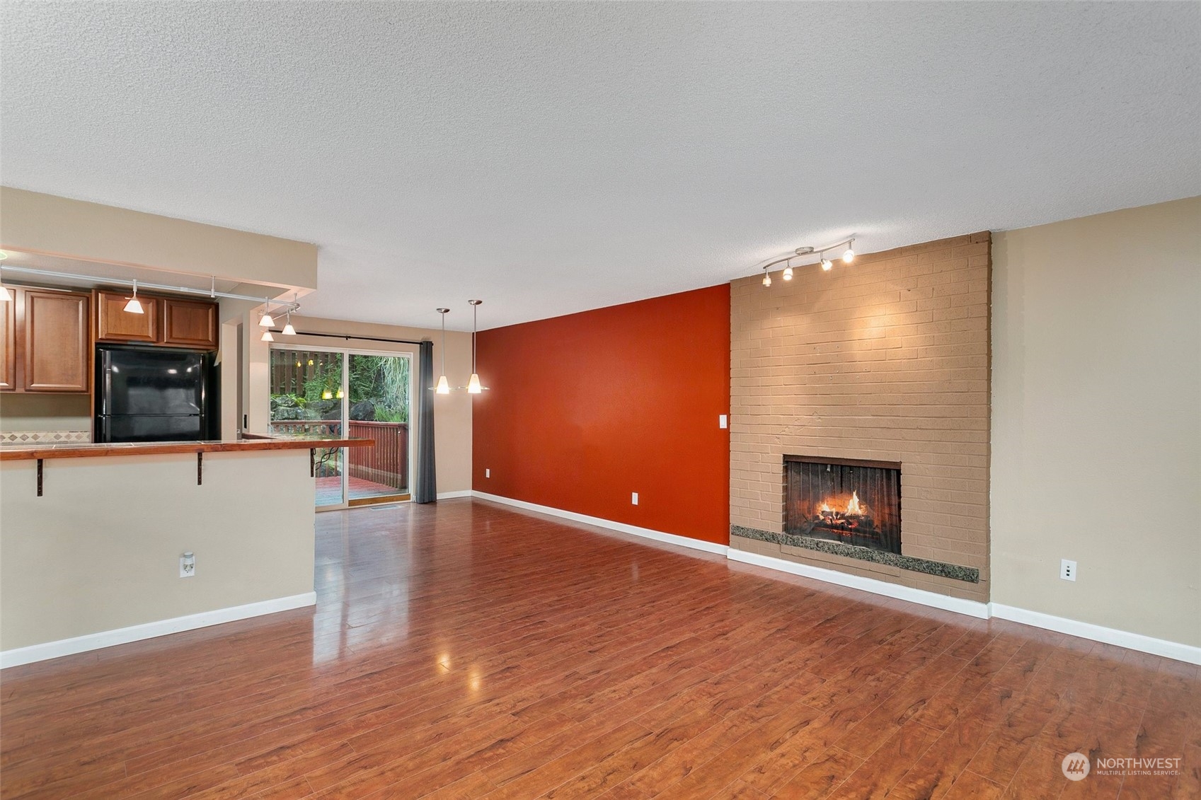 26007 36th Place South Kent, WA 98032 - Photo 3 of 37 a view of an empty room with wooden floor and a fireplace