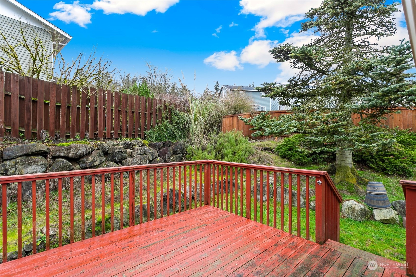 26007 36th Place South Kent, WA 98032 - Photo 7 of 37 a balcony with wooden floor and trees in the back
