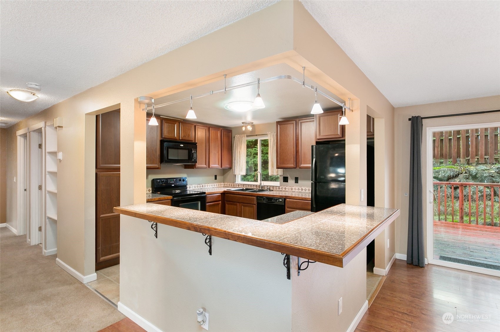 26007 36th Place South Kent, WA 98032 - Photo 8 of 37 a kitchen with stainless steel appliances a sink and a refrigerator