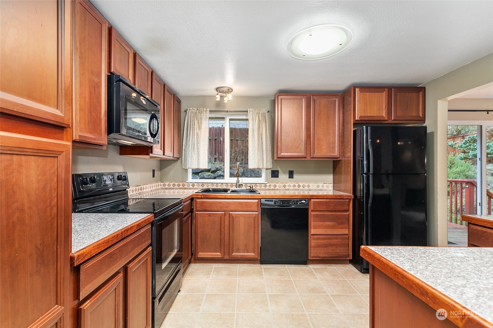 26007 36th Place South Kent, WA 98032 - Photo 10 of 37 a kitchen with stainless steel appliances granite countertop a sink stove and refrigerator