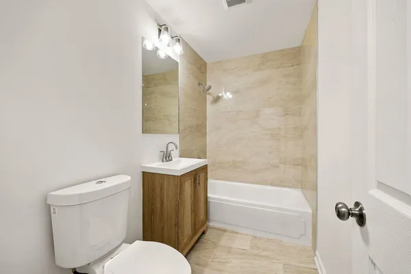 a bathroom with a toilet a sink and bathtub